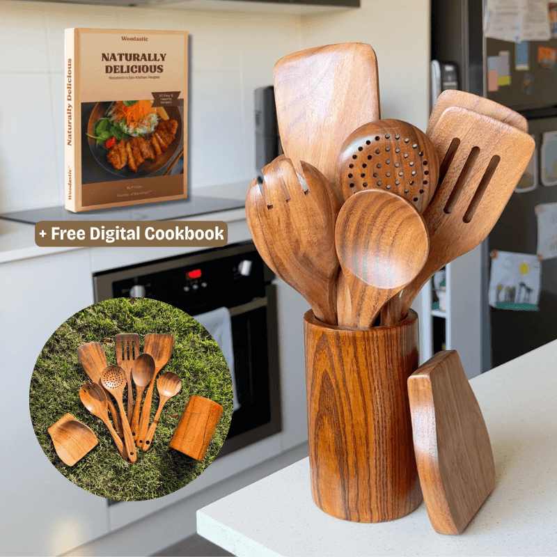 Wooden kitchen utensils set in a holder with a digital cookbook on a kitchen counter.