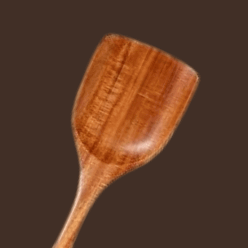 Wooden spatula on a brown background