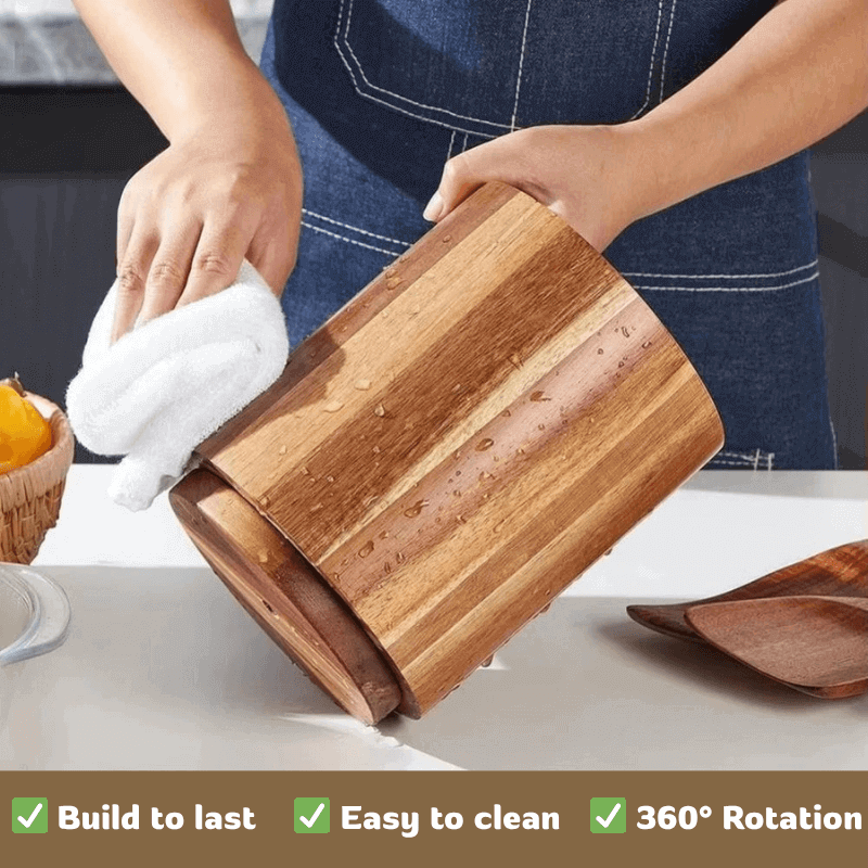 Person cleaning a wooden utensil holder with a cloth on a kitchen counter.