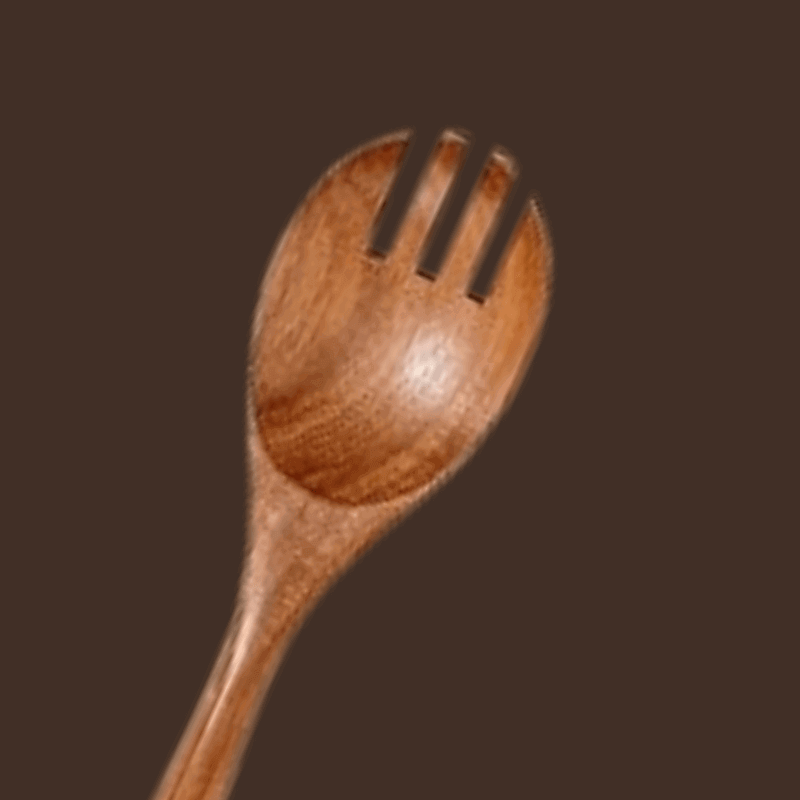 Wooden spoon with fork-like ends on a brown background