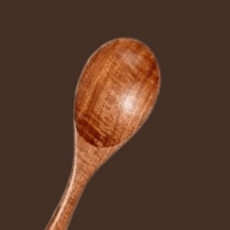 Wooden spoon on a brown background