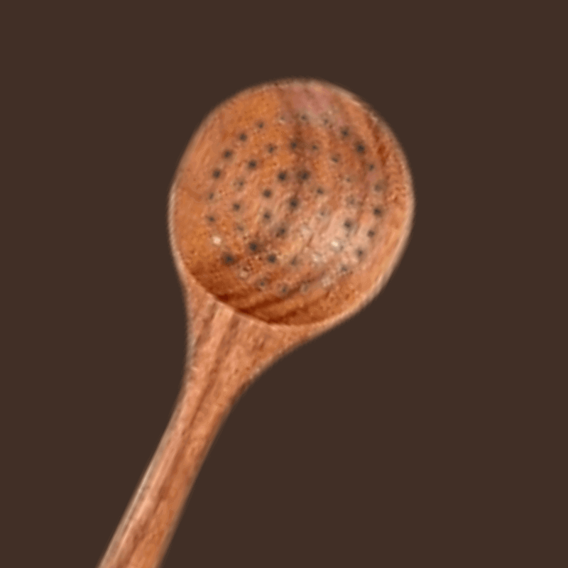 Wooden spoon with a textured wooden ball on a brown background