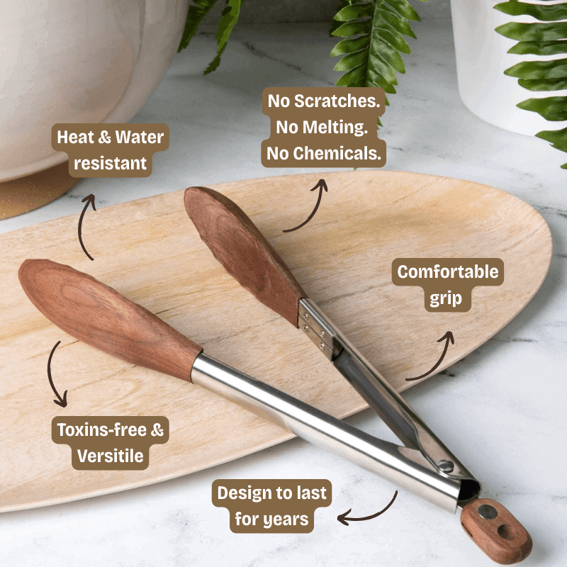 Wooden tongs with text highlighting features on a marble surface with plants in the background