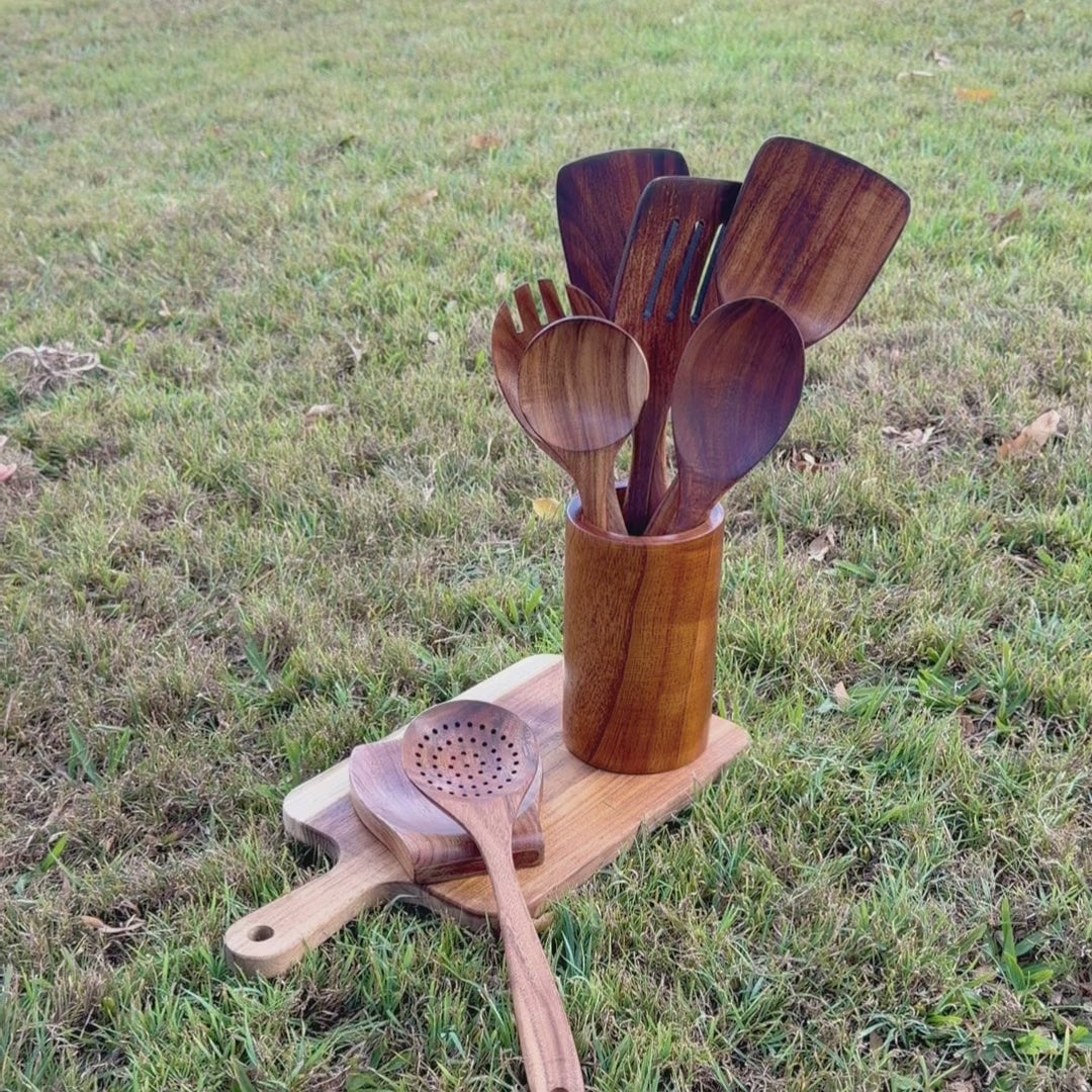 Organic mineral oil showing next the woodastic 9 pcs utensil set and a grass background