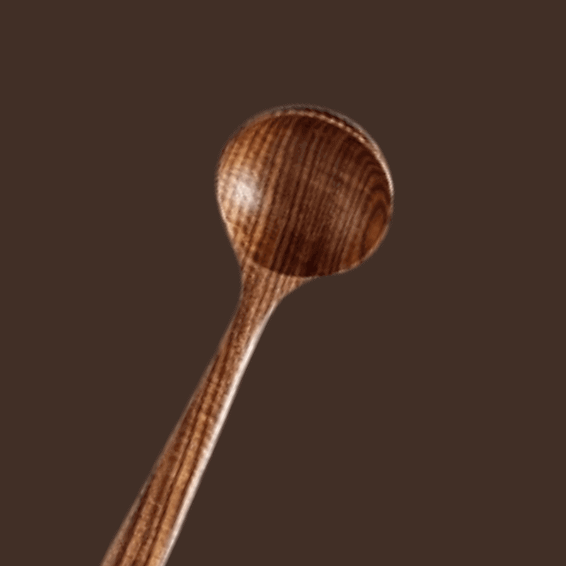 Wooden spoon on a brown background